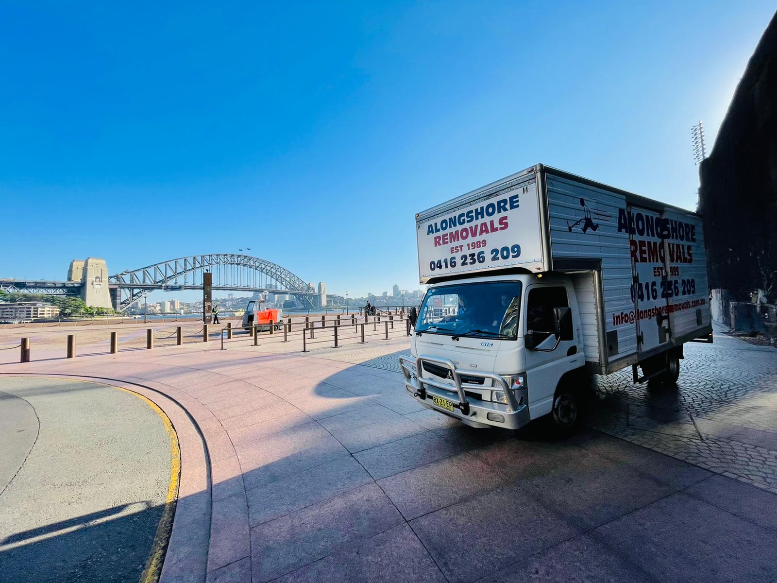 Alongshore Removals truck parked in front of the Sydney Harbour Bridge