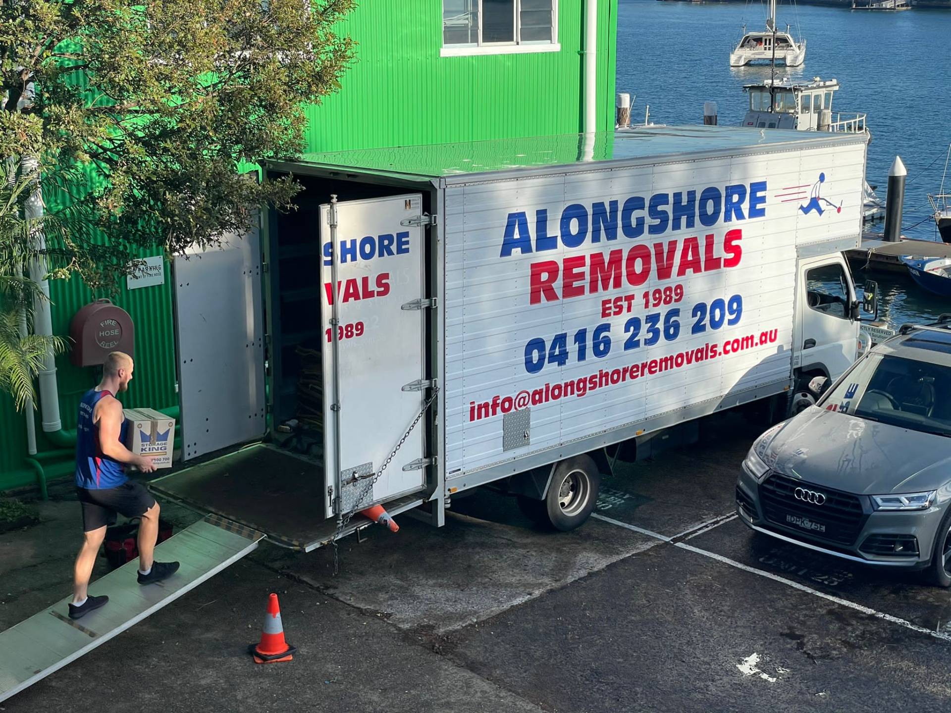 Alongshore crew loading a truck beside the water on a Sydney residential move